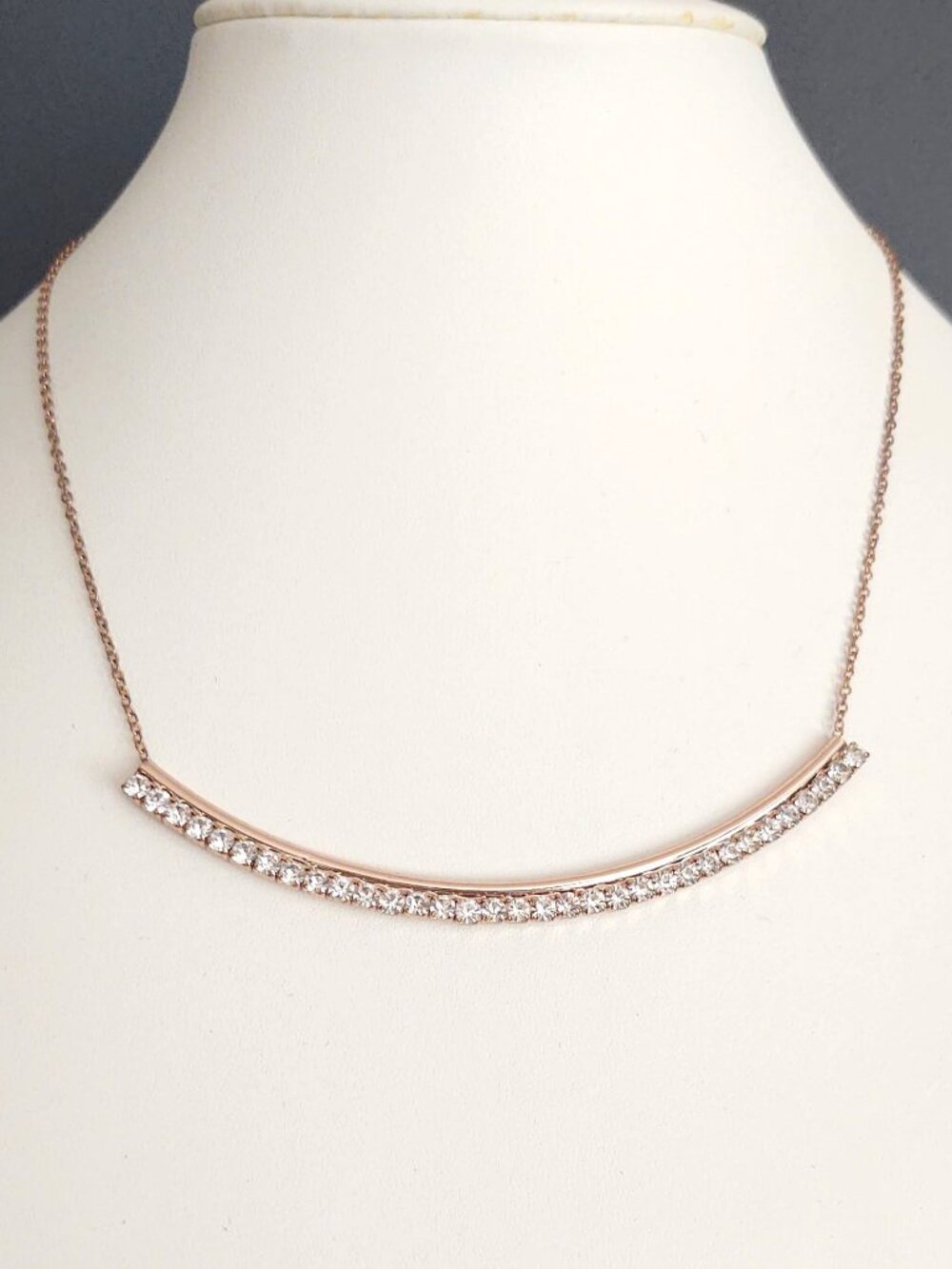 Gold curved bar necklace with faux diamonds